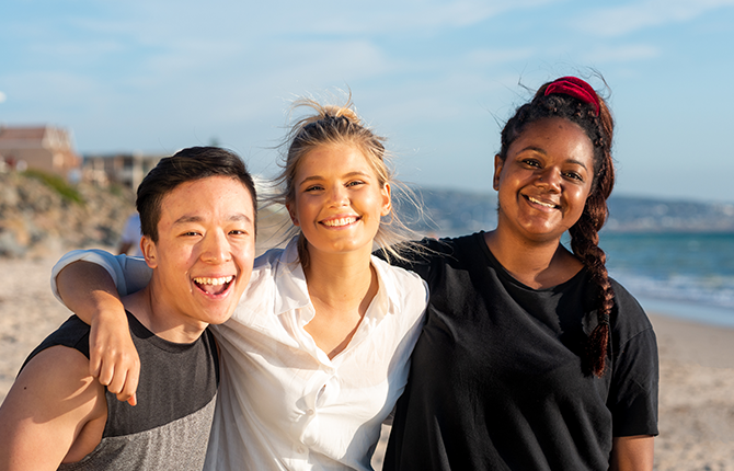 International students smiling and having fun at the beach in South Australia